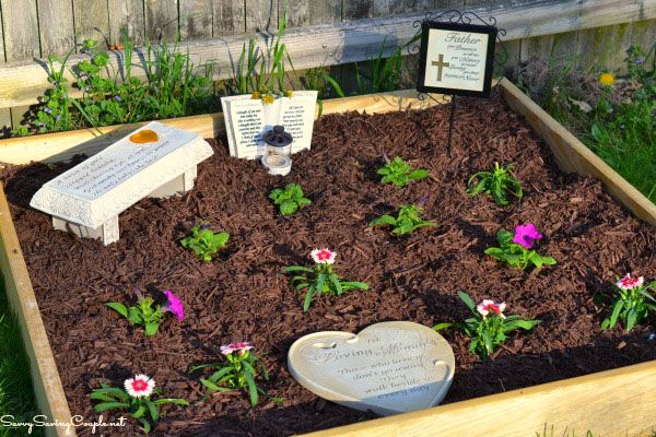 a wooden box filled with dirt and flowers next to a plaque that says, i love you