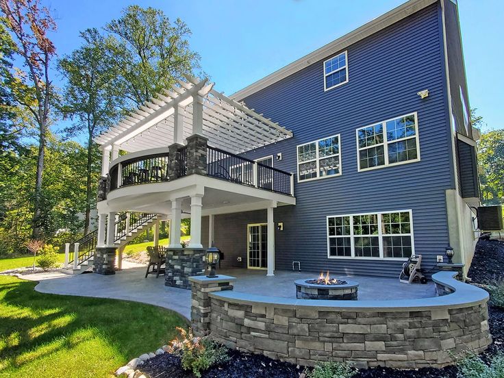 a large house with a fire pit in the front yard