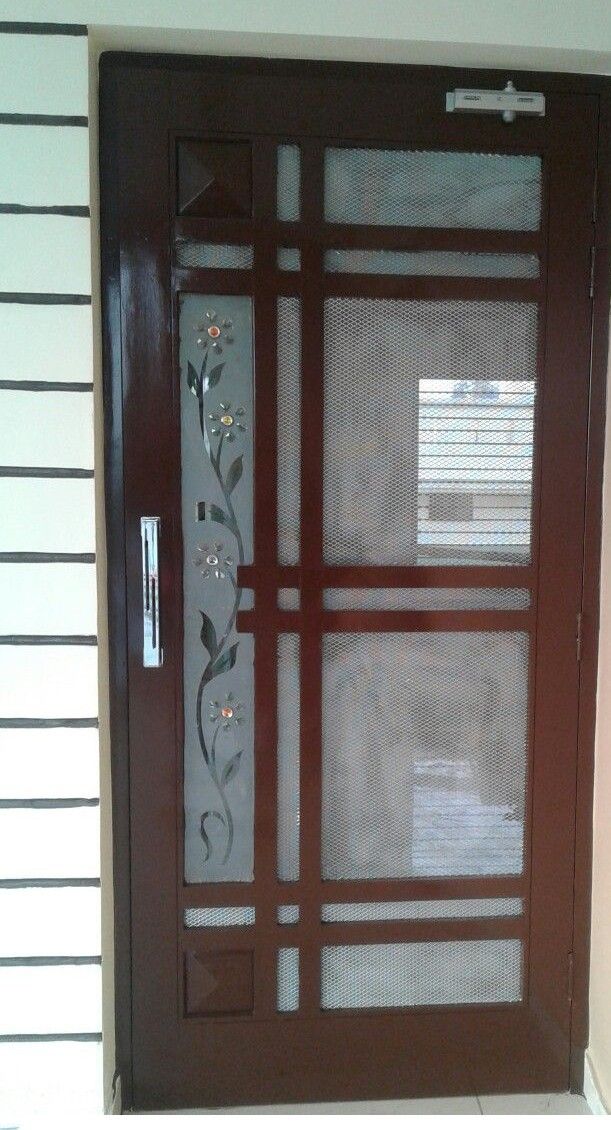 the front door is decorated with flowers and leaves on it's glass paneling