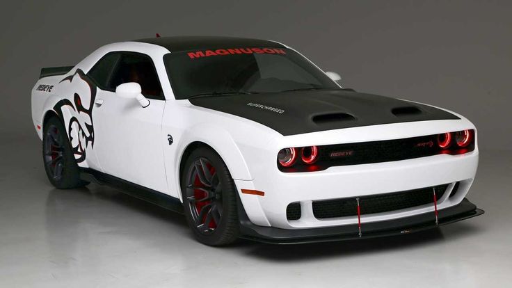 a white sports car with red lettering on the hood and tail lights is shown in front of a gray background