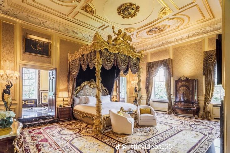 an ornate bedroom with gold and white decor, including a canopy bed in the center