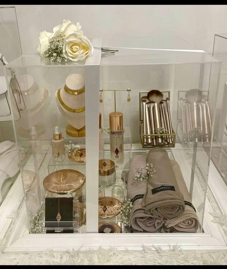 a display case filled with lots of different types of items and flowers on top of it