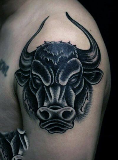 a bull head tattoo on the left shoulder and upper half of his arm is shown