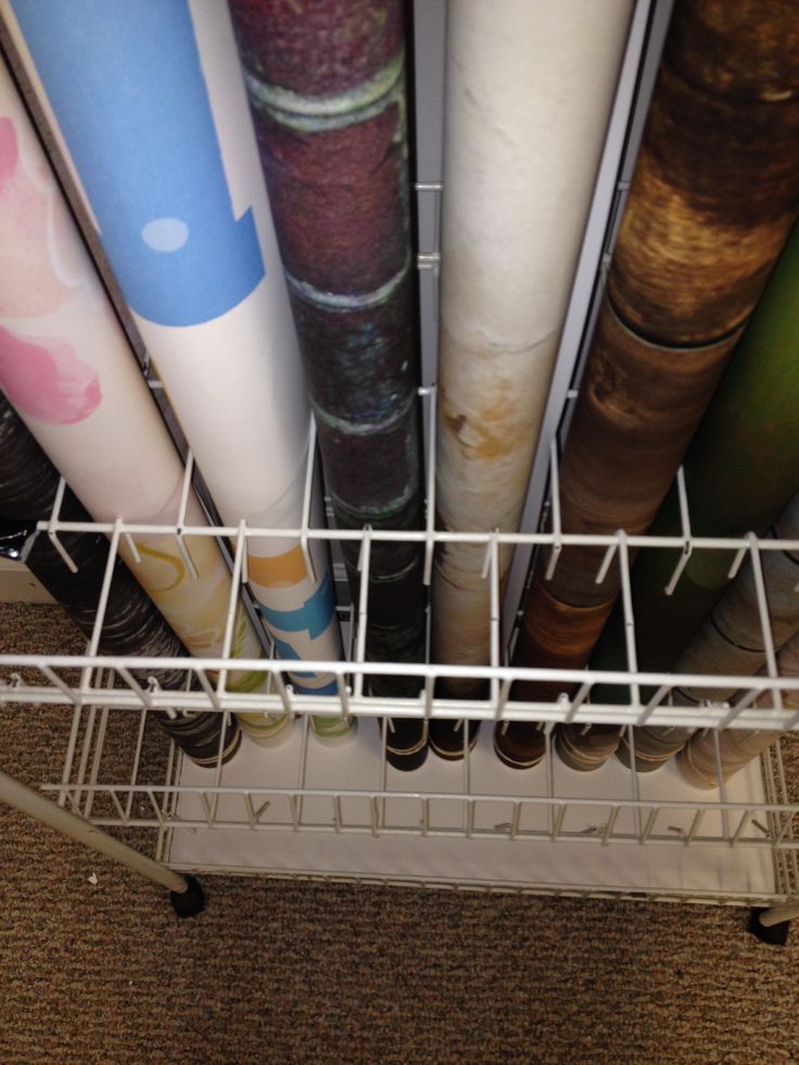 the bottom rack of a dishwasher is filled with different colored rolls of paper