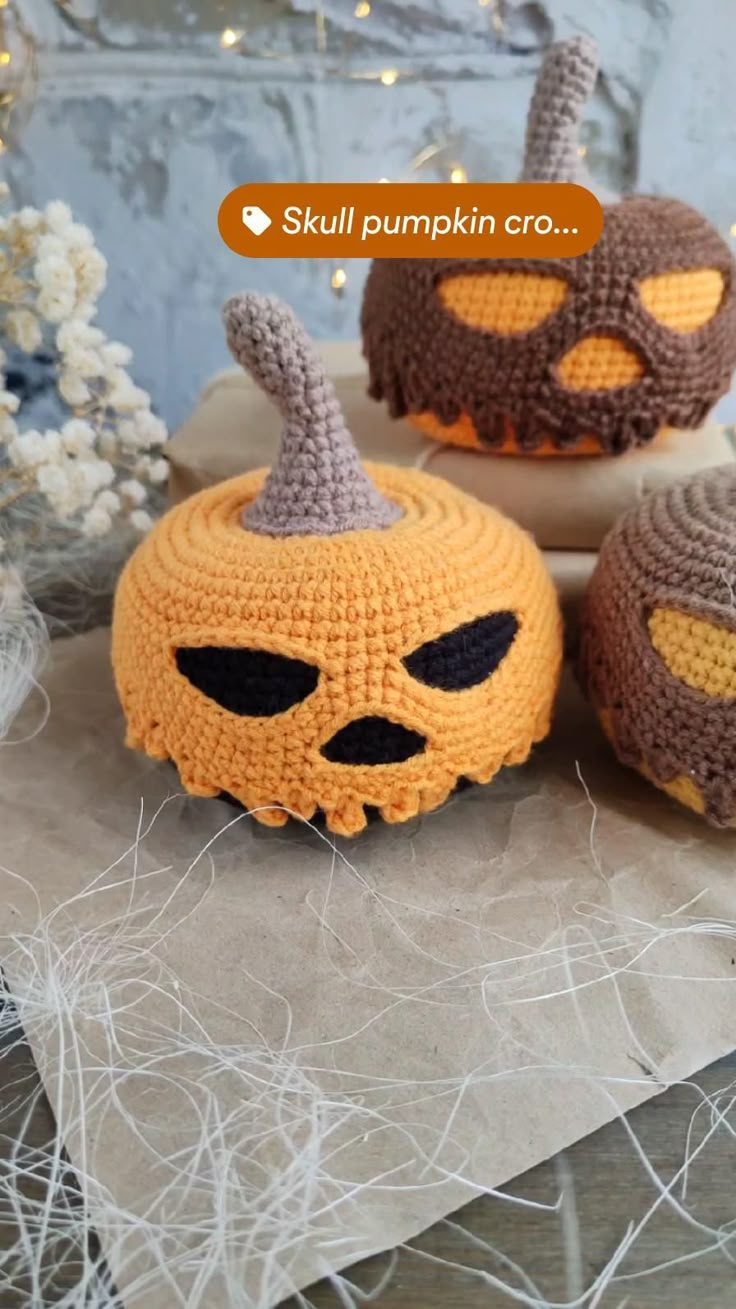 three crocheted pumpkins sitting on top of a table