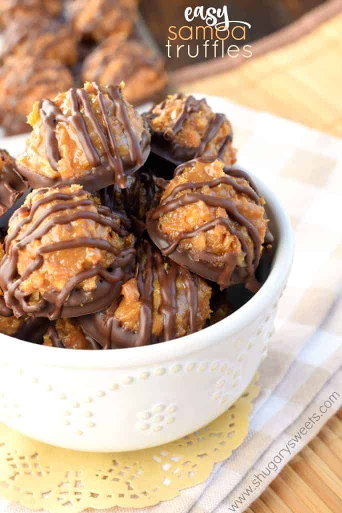 a bowl filled with chocolate covered cookies on top of a table