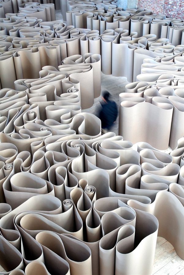 many rolls of paper sitting on top of each other in the middle of a room