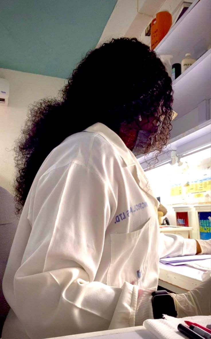 a woman in a lab coat working on something