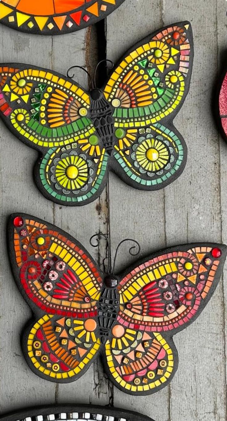 colorful butterflies are hanging on the side of a building