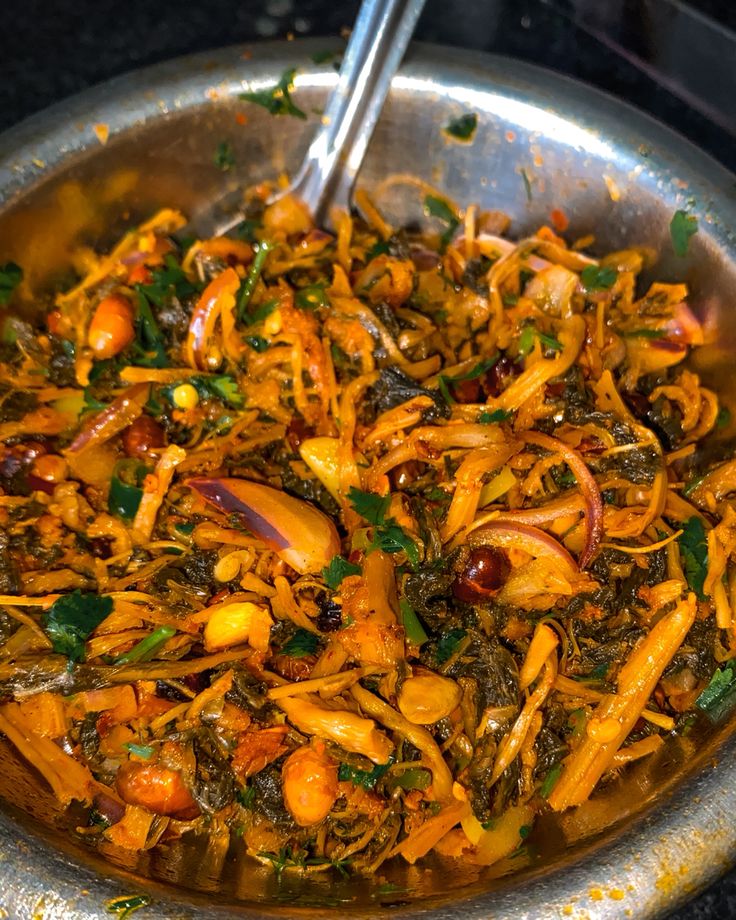 a pan filled with food sitting on top of a stove