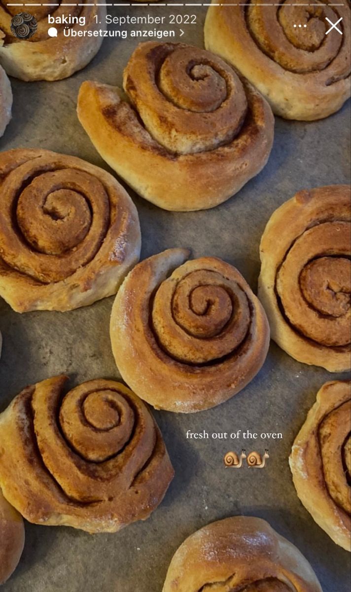 several cinnamon rolls sitting on top of a baking sheet