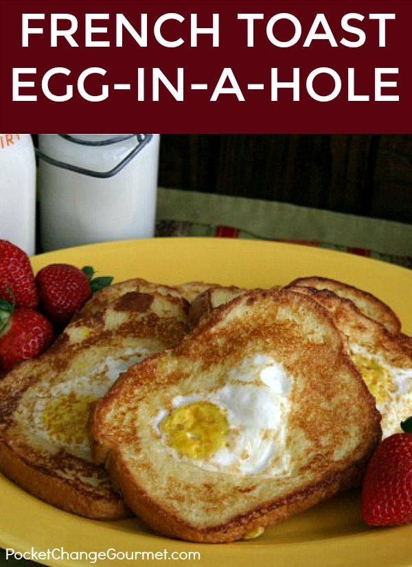 french toast egg - in - a - hole on a yellow plate with strawberries and milk