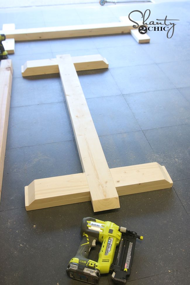 a cordless drill is laying on the floor next to some wood planks that have been cut in half