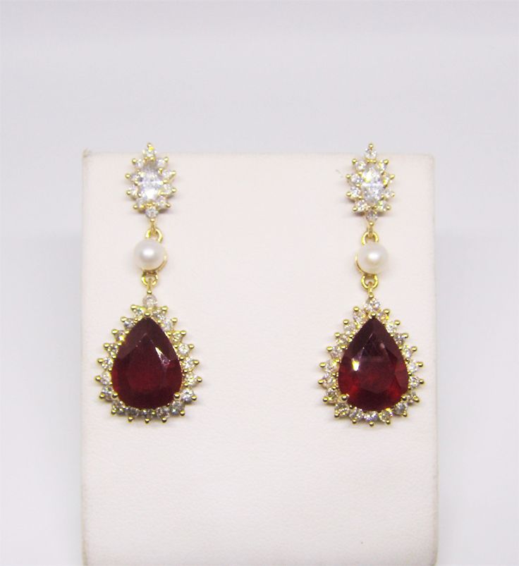 14k Yellow Gold Earring with Ruby and Natural Diamonds and Pearls. 14k Gold weight: 7.84 g approx. Hallmarked as per EU standards. Natural Ruby lead-filled  - 6.57 + 5.41 = 11.98 ct approx - Beautiful red color - Natural pattern inclusions, fractures and cavities filled with lead glass. IGE Certified - D-20610. Natural Diamond Rounds: 60 pcs - 0.90 ct approx, I - J color, VS-SI clarity.  Natural Diamond Marquis shapes: 2 pcs - 0.25 ct, H - I color, VS clarity. Fresh Water pearls: 2 pcs - 0.15 ct  Earring Size -  40 x 15 mm overall Length and Width. Post Length  - 10 mm Post Thickness - 0.60 mm Condition:  As new. Barely used. Evergreen style handmade Earring - very royal look - kind of estate jewelry pattern - quite a good size of Rubies - big face up - a delight for jewelry collectors and Elegant Pear-shaped Jewelry For Evening, Classic Evening Ruby Jewelry, Formal 14k Yellow Gold Bridal Earrings, Formal Teardrop Pierced Bridal Earrings, Formal Teardrop Bridal Earrings Pierced, Formal Teardrop Bridal Earrings, Gold Cubic Zirconia Earrings With Gemstones, Gold Gemstone Diamond Earrings For Anniversary, Evening Teardrop Gold-plated Jewelry