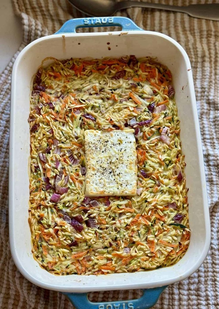 a casserole dish filled with noodles and vegetables