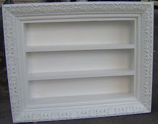 an empty white book shelf sitting on the ground