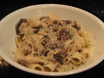 a white bowl filled with pasta and mushrooms