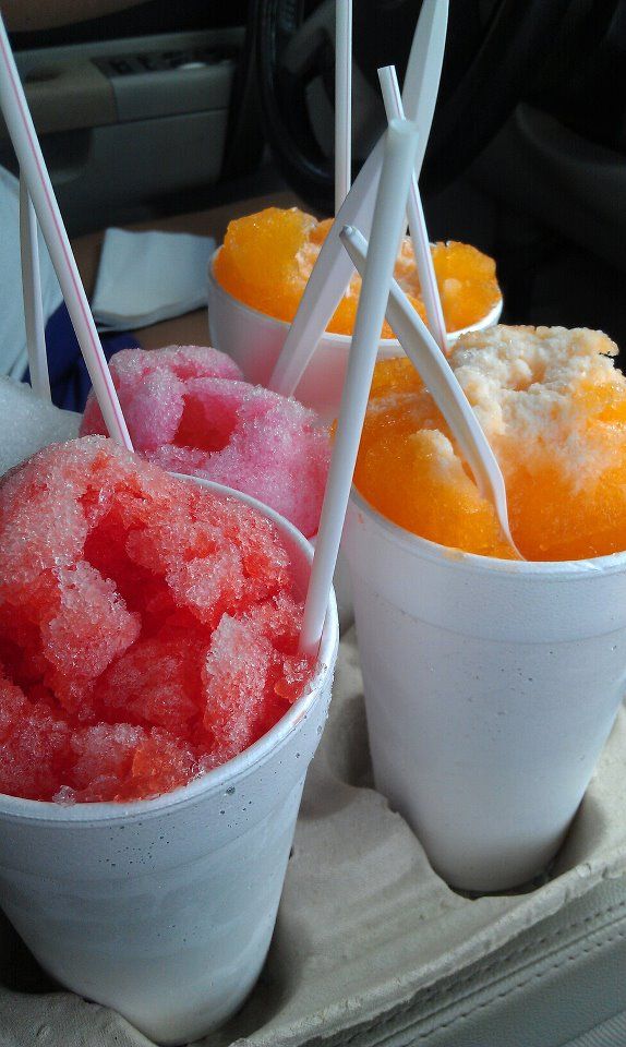 three bowls filled with different types of ice cream on top of a tray in a car