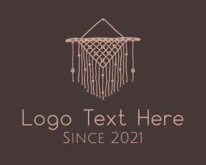 a logo with a dream catcher hanging from it's side on a brown background