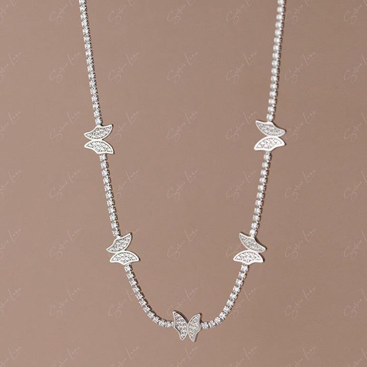 Enhance your fine jewelry collection with this exquisite cubic zirconia butterfly choker necklace. The intricate butterfly design, set on a solid 925 sterling silver chain, adds a touch of elegance to any outfit. Versatile enough to layer with longer necklaces, this piece is a must-have for any jewelry lover. Whether worn every day or for a special occasion, this necklace will make you feel like a beautiful bride. Materials: 925 sterling silver, cubic zirconiaFinish: platinum plateChoker length: Elegant Cubic Zirconia Butterfly Necklace With Clavicle Chain, Elegant Sterling Silver Butterfly Necklace With Butterfly Clasp, Elegant Butterfly Necklace With Cubic Zirconia, Elegant Cubic Zirconia Butterfly Necklace, Delicate Jewelry With Cubic Zirconia Butterfly Charm, Elegant Silver Butterfly Necklace With Charm, Butterfly-shaped Cubic Zirconia Necklace, Delicate Butterfly Jewelry With Cubic Zirconia, Elegant Silver Butterfly Necklace With Butterfly Clasp