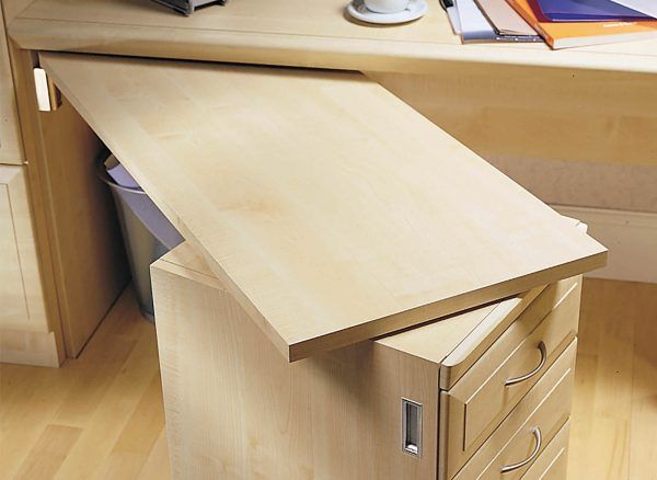 a wooden desk with drawers and a laptop on it