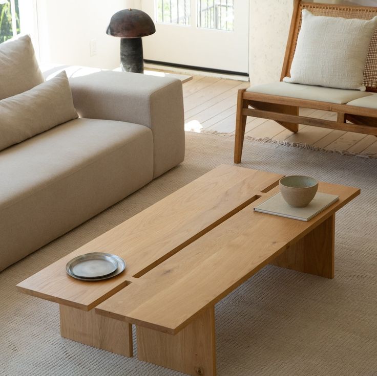 a living room with two couches and a coffee table in the middle of it