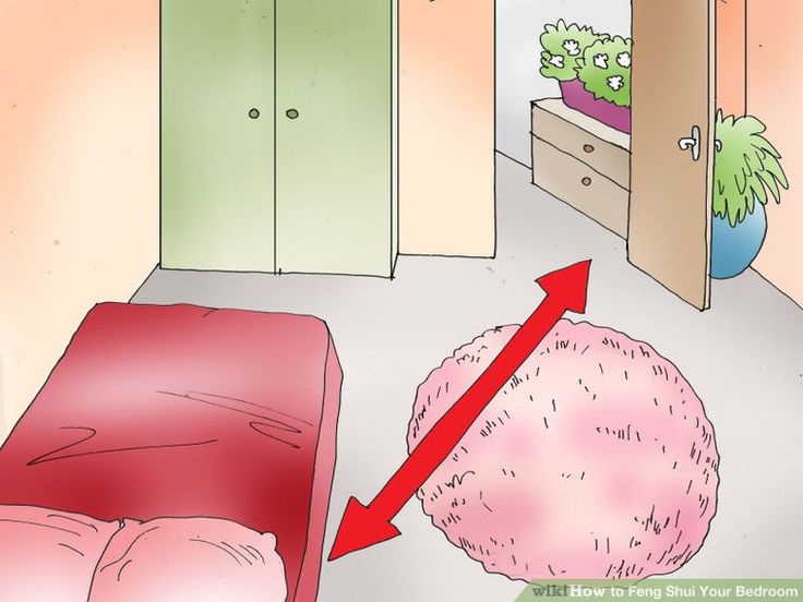 a bedroom with a pink bed and green cupboards next to a red chair on the floor