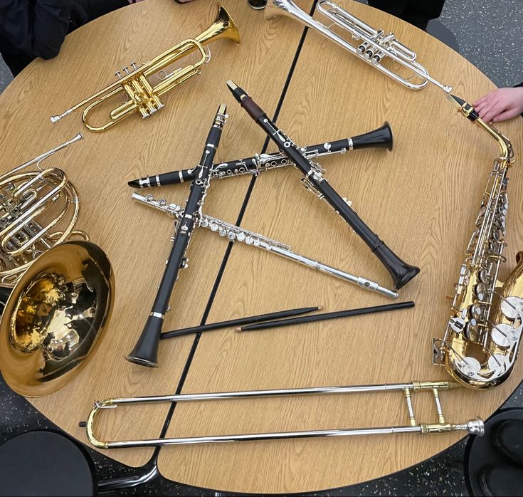 a group of musical instruments sitting on top of a wooden table