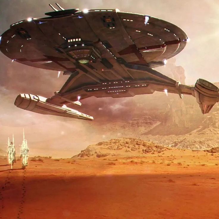 two futuristic ships flying over a desert landscape