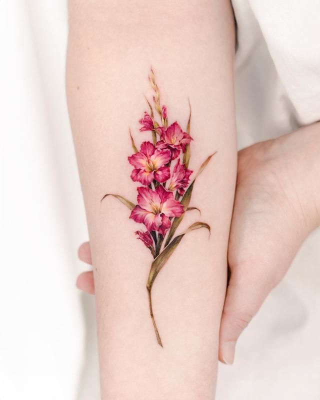 a woman's arm with pink flowers on it