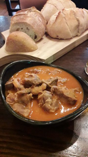 a bowl of soup and bread on a table