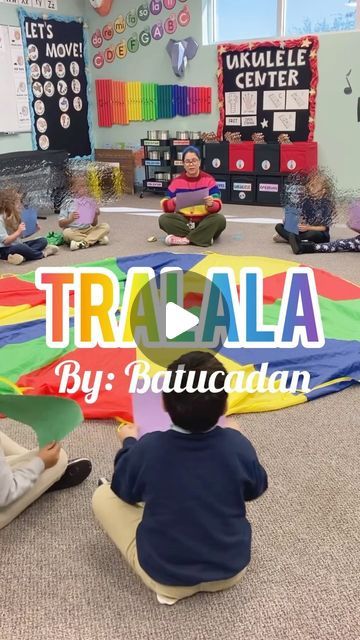 children sitting on the floor in front of a colorful sign that says tracula by bauaculaan