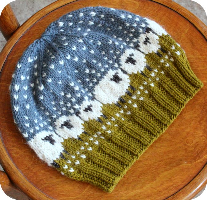 a knitted hat sitting on top of a wooden chair