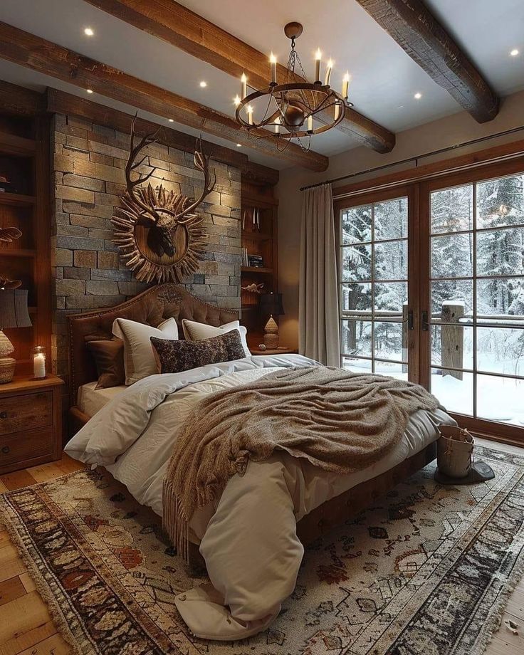 a large bed sitting under a chandelier in a bedroom next to a window