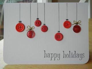 a white card with red buttons hanging from it's sides and the words happy holidays