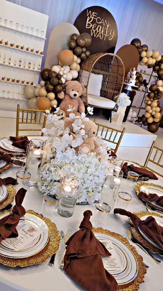 a table set up for a baby shower with teddy bears