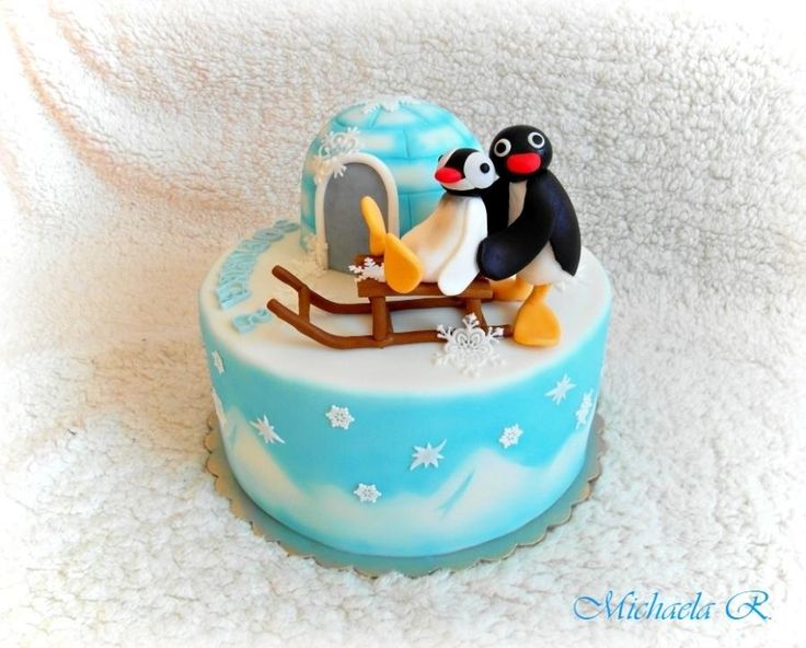 there is a cake that has penguins on it