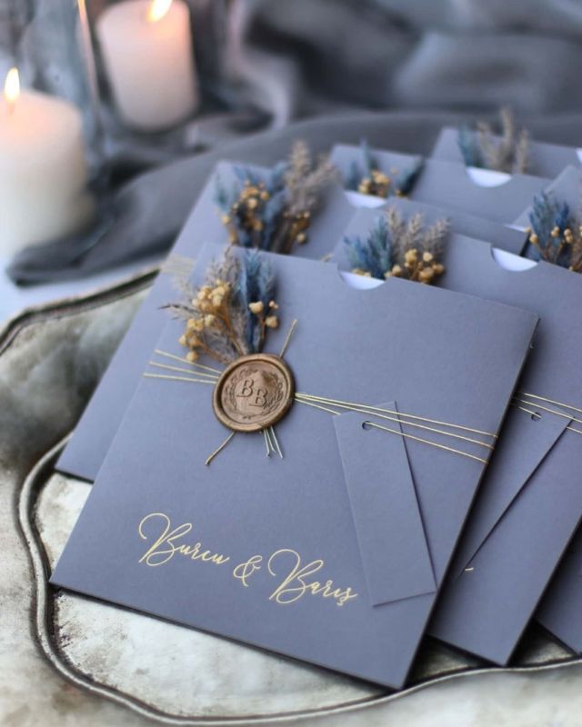 wedding stationery with wax stamp and dried lavenders on them, sitting next to candles