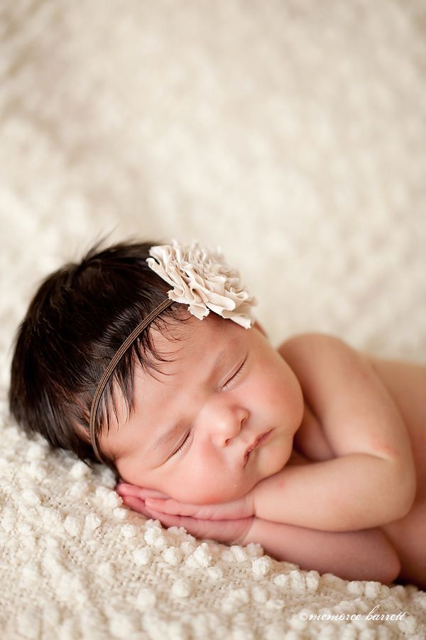 a baby is sleeping on a white blanket