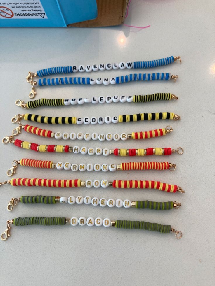 several different types of fishing lures lined up on a white counter top in a row