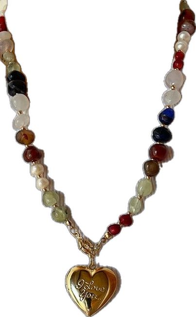 a necklace with a heart shaped pendant and multicolored stones on it's chain