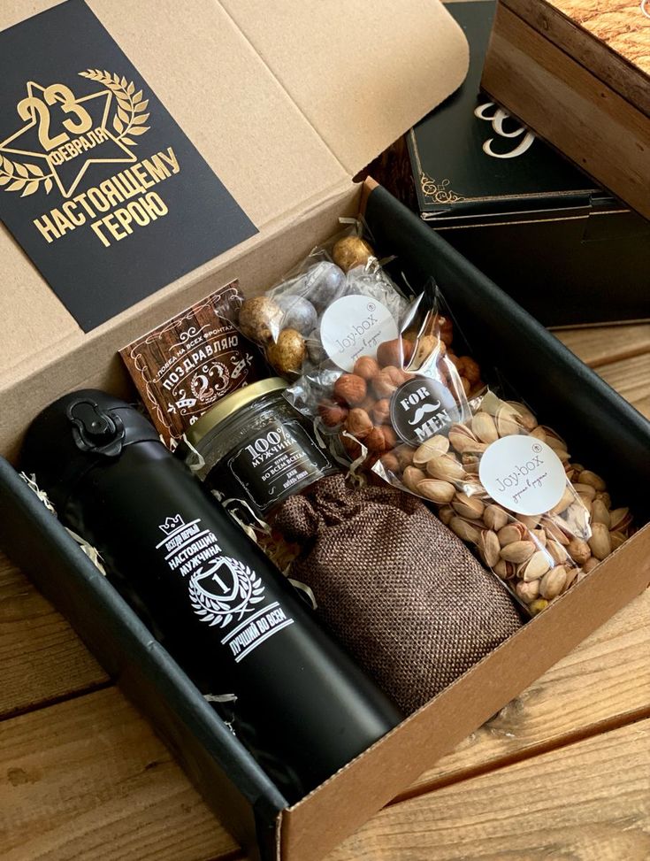 an open box filled with different types of nuts and coffee beans on top of a wooden table