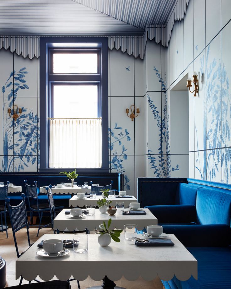 the interior of a restaurant with blue and white decor