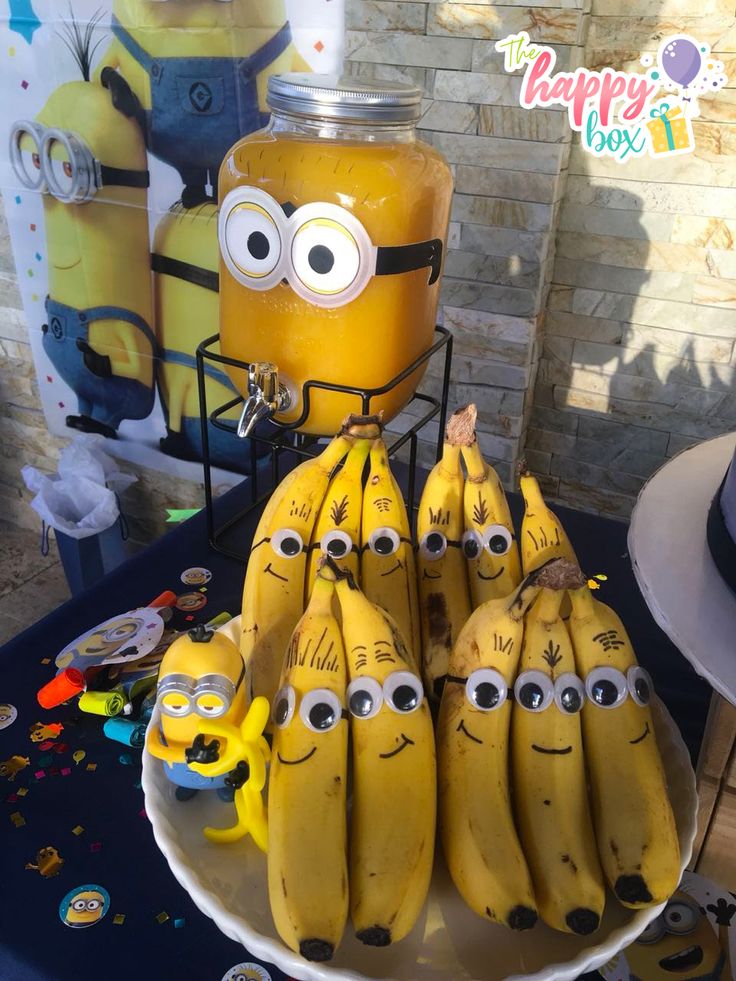 a bunch of bananas sitting on top of a table next to a minion jar