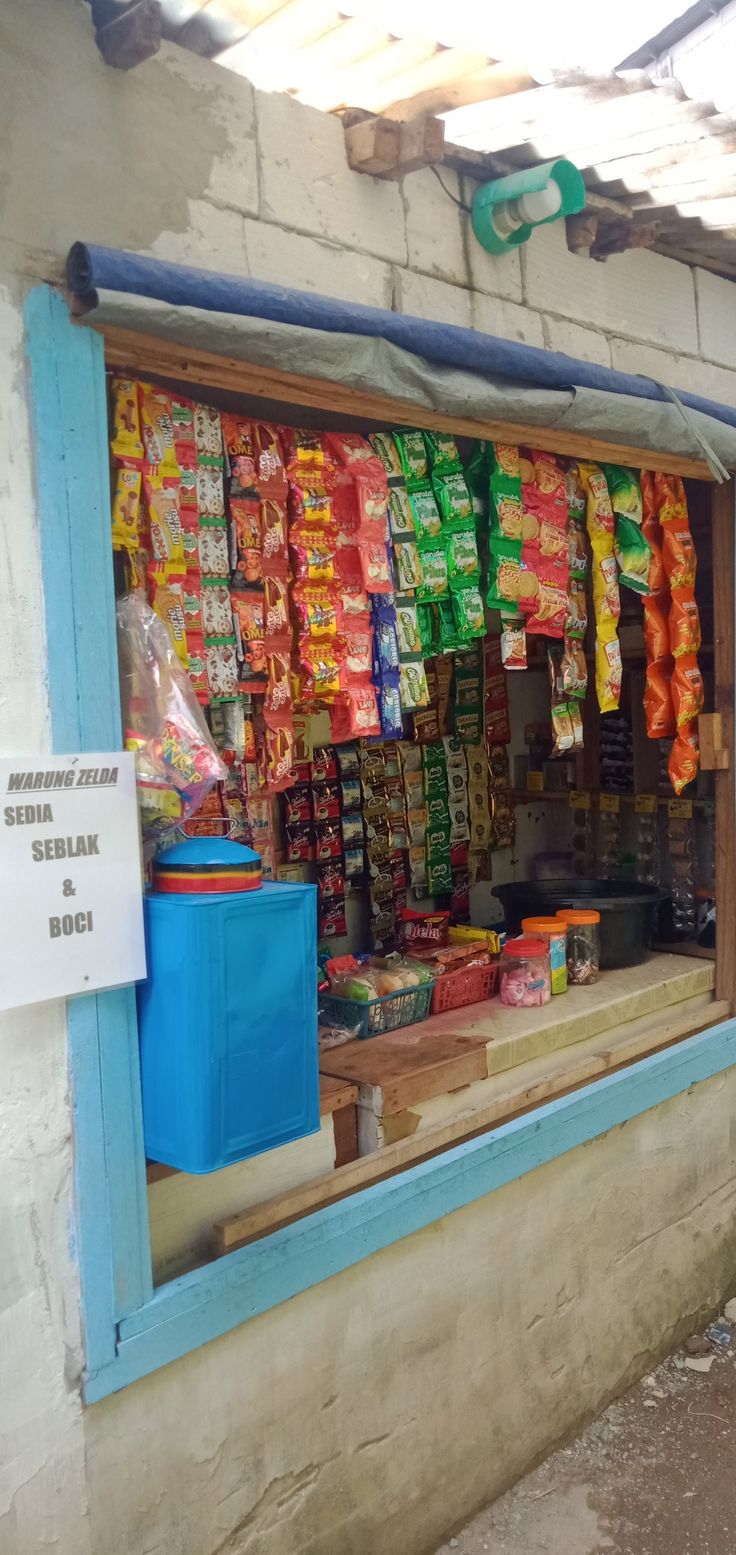 a store front with bags and food in the window