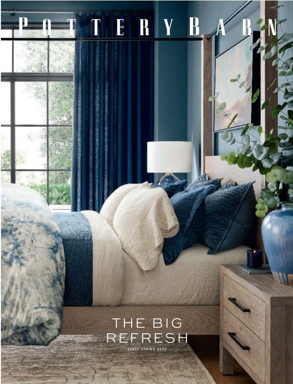 a bedroom with blue walls and white bedding, plants on the side of the bed