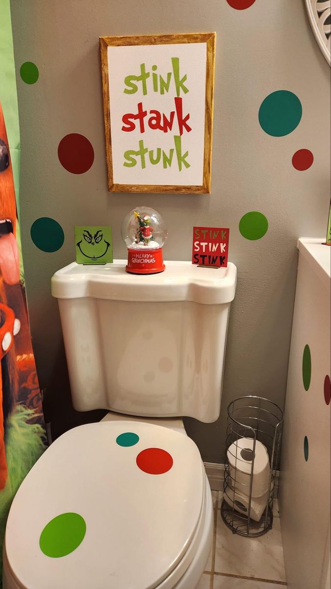 a white toilet sitting in a bathroom next to a green and red polka dot wall