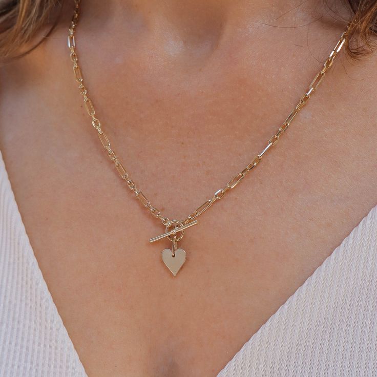 Add a romantic touch to your layered necklaces with this dainty heart necklace made of gold. A perfect heart hanging from a marvelous staple chain. This fine necklace is easy to wear with everything, fits perfectly with other necklaces, and also looks fabulous on it's own. This is a must-have necklace. All features can be customized! Talk to us Our jewelry is carefully handmade in our atelier Our diamonds are conflict free To order by phone click here>> +972(0)722991000 Elegant 14k Gold Filled Heart Necklace, 14k Gold-filled Heart Necklace With Heart Charm, 14k Gold Heart Cut Necklace With Adjustable Chain, Elegant Heart Toggle Necklace, Everyday Heart Pendant Charm Necklace With Delicate Chain, Gold Plated Double Heart Charm Necklace, Everyday 14k Yellow Gold Filled Heart Necklace, Everyday Heart-shaped Paperclip Chain Jewelry, Delicate Heart Pendant Charm Necklace With Adjustable Chain