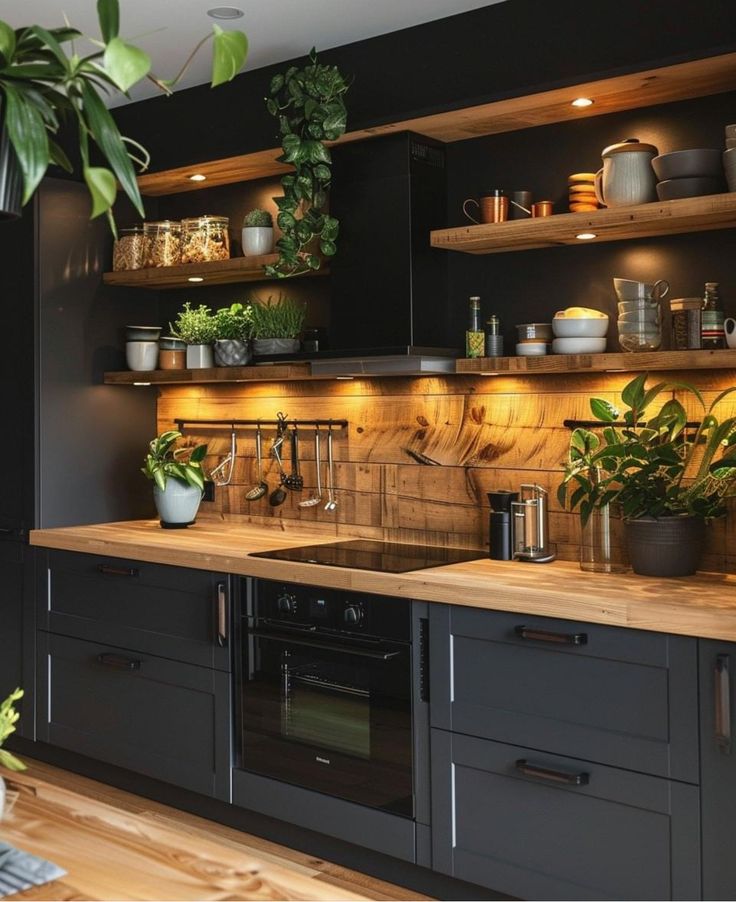 a kitchen filled with lots of plants and pots on top of wooden counter tops next to black cabinets