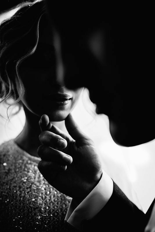 black and white photograph of a man and woman holding each other's hand together